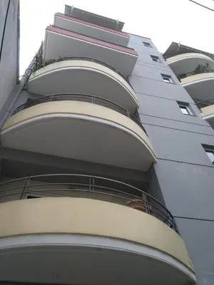 a tall building with balconies on the side of it at Chania Central Flat in Chania Town