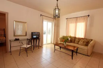 a living room with a couch and a table at Lambrinos Suites in Plataniás