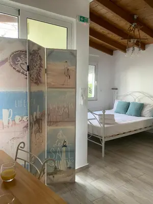 a room with a bed and a table in a room at Vitis Vinifera Tranditional Studio Apartment in Kissamos