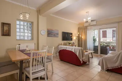a living room with a table and a dining room at Natalia Guest House in Chania Town