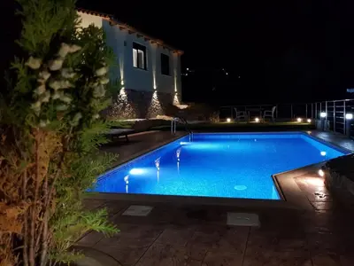 a swimming pool at night with a house at Chania Village - Charoupia & Daphne Villas Private Pool - BBQ - Afrata in Afráta