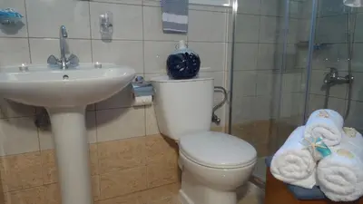 a bathroom with a toilet and a sink at Despina Studios in Agia Marina Nea Kydonias