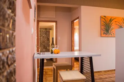 a table in a room with a bottle of wine at Nireas Hotel in Kato Daratso