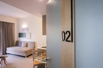 a living room with a couch and a table at IRINI STALOS Apartments in Stalos
