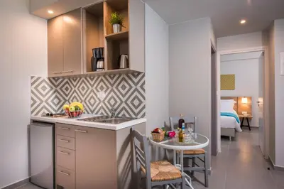 a kitchen with a sink and a table in a room at IRINI STALOS Apartments in Stalos