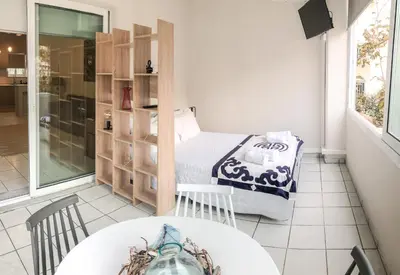 a small room with a bed and a table at Sofia City Beach 3 Apts Nea Chora Chania steps from the beach in Chania Town