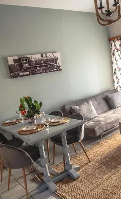 a living room with a table and a couch at Sofia City Beach 3 Apts Nea Chora Chania steps from the beach in Chania Town