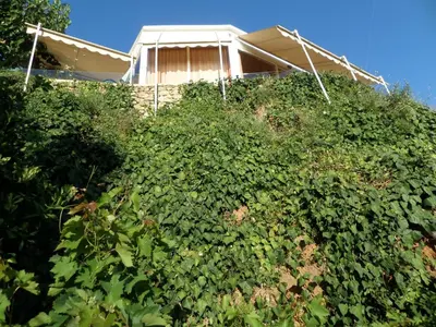 a house on top of a hill with bushes at Endless Blue in Ravdhoúkha