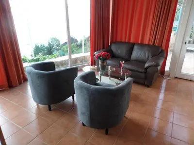 a living room with a couch and chairs and a table at Endless Blue in Ravdhoúkha