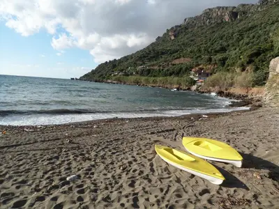 two yellow surfboards on a sandy beach next to the ocean at Endless Blue in Ravdhoúkha