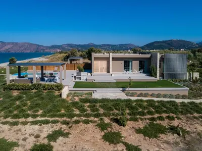 a house with a view of the ocean at Youphoria Beach Front Villas in Korfalónas