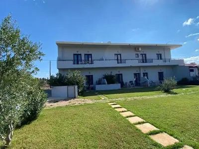 a house with a yard in front of it at Blue Sky in Frangokastello