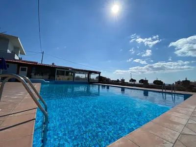 a large swimming pool with blue water at Blue Sky in Frangokastello
