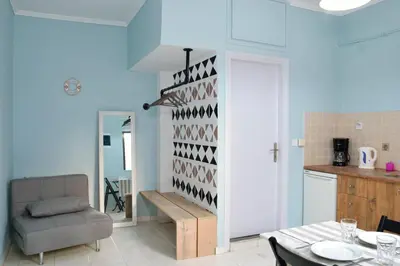 a living room with a table and a chair at Katerina Apartments in Kato Daratso
