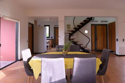 a dining room with a yellow table and chairs at Red Castle in Souda