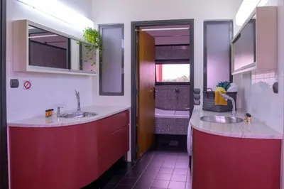 a bathroom with two sinks and a tub at Red Castle in Souda