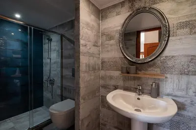 a bathroom with a sink and a mirror at Andromia Studios & Apartments in Agia Marina Nea Kydonias