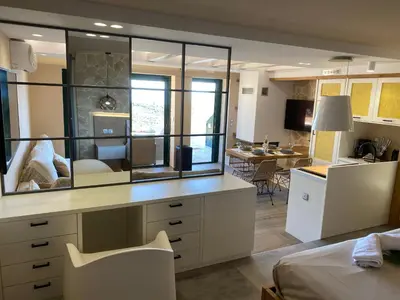 a bedroom with a desk with a large mirror at Papaduke House in Kalyves