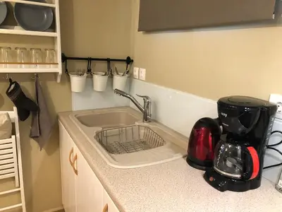 a kitchen counter with a sink and a mixer at Papaduke House in Kalyves