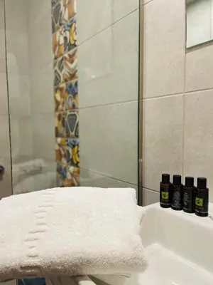 a bathroom with a sink with a towel and a mirror at Amaryllis in Plataniás