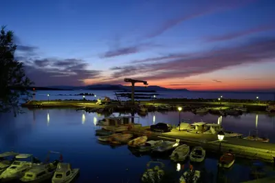 a group of boats docked in a marina at night at Urban Studios Manos in Chania Town