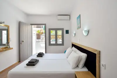 a bedroom with two beds with white sheets at Urban Studios Manos in Chania Town
