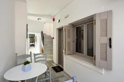 a room with a table and chairs and a window at Urban Studios Manos in Chania Town