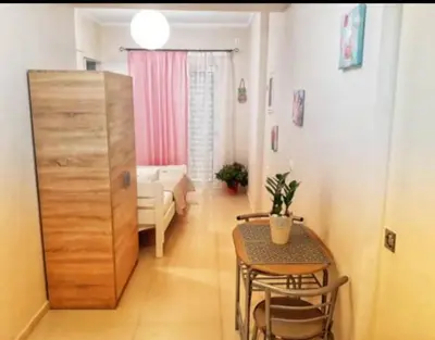 a living room with a table and a dining room at Konstantina's studio near the beach in Chania Town