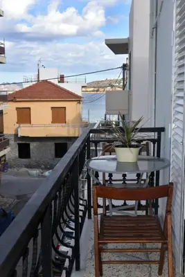 a table and chairs on a balcony with a view of the water at Apartment in Koomkapi in Chania Town