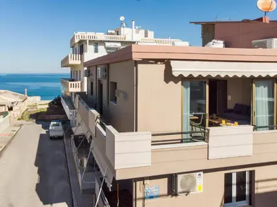 an apartment building with balconies and a street at Mirma Luxury Apartment in Chania Town