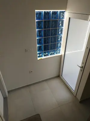 a room with a large window and a door at The 3 Brothers' Apts in Chania Town
