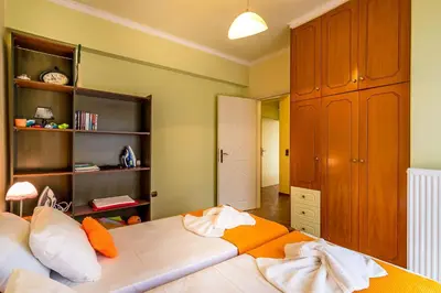 a bedroom with a large bed and a book shelf at Villa Helen 200m from the beach in Tersanas BY APOKORONAS-VILLAS in Tersanas