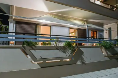a balcony of a house with potted plants on it at Aromatic Home in Kissamos