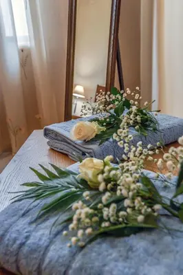 a bouquet of flowers sitting on top of a bed at Aromatic Home in Kissamos