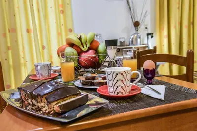 a table with a chocolate cake and a plate of food at Aromatic Home in Kissamos
