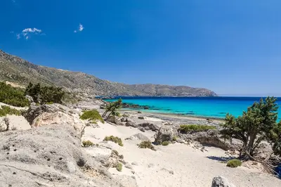 a view of a beach with blue water and mountains at VILLA ASTERAKI private pool, magic sunsets, near Elafonisi in Ãyios FÃ³tios