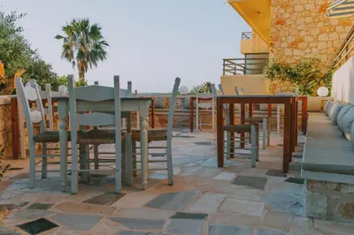 a patio with a table and chairs on a patio at Creta Vitalis in Kalathas