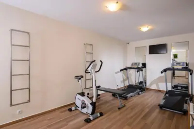 a gym with two treadmills and two ellipticals at Atlantica Amalthia Beach Hotel - Adults Only in Agia Marina Nea Kydonias