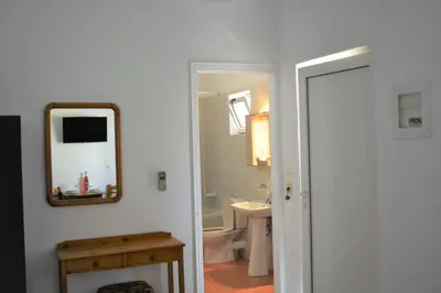 a bathroom with a mirror and a sink at Raph's Studios-Apts By The Sea in Agia Marina Nea Kydonias