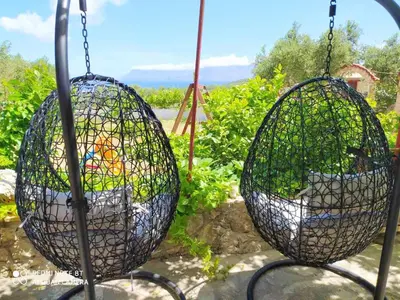 two wire baskets hanging in a garden at Wood & Stone in Kissamos