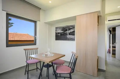 a dining room with a table and chairs at Athina Suites Luxury Suites Near The Sea Platanias in Plataniás