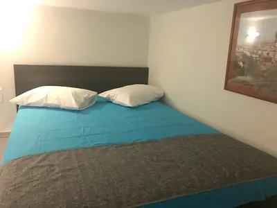 a bedroom with a bed with two pillows on it at Odyssey Apartment in Palaiochóra