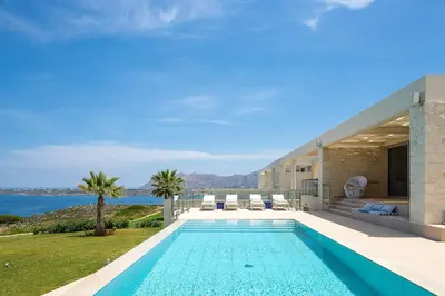 a house with a swimming pool with a view of the ocean at Elias Luxury Villa in Kalathas