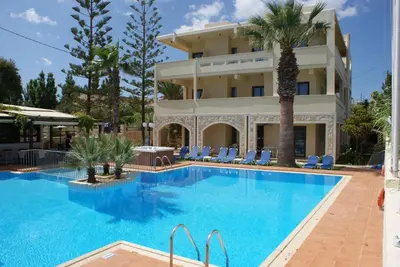 a large swimming pool in front of a hotel at Sunny Suites in Maleme