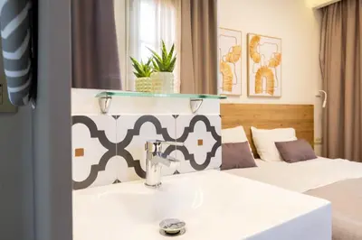 a hotel room with a sink and a bed at Cretan Berry Portou in Chania Town