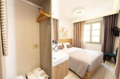 a hotel room with a bed and a sink at Cretan Berry Portou in Chania Town