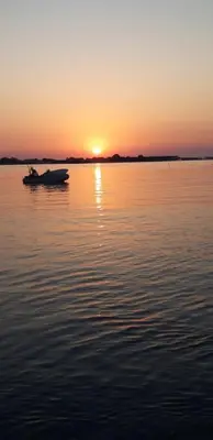 a boat on a body of water at sunset at Horio House in Límni
