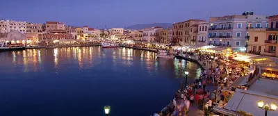 a group of people walking along a river in a city at Marias Studios in Chania Town