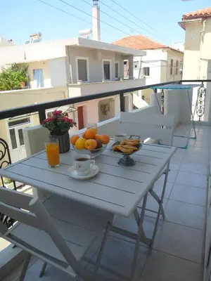 a white table with a bowl of fruit on a balcony at Marias Studios in Chania Town