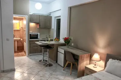 a kitchen with a table and a counter top at Marias Studios in Chania Town